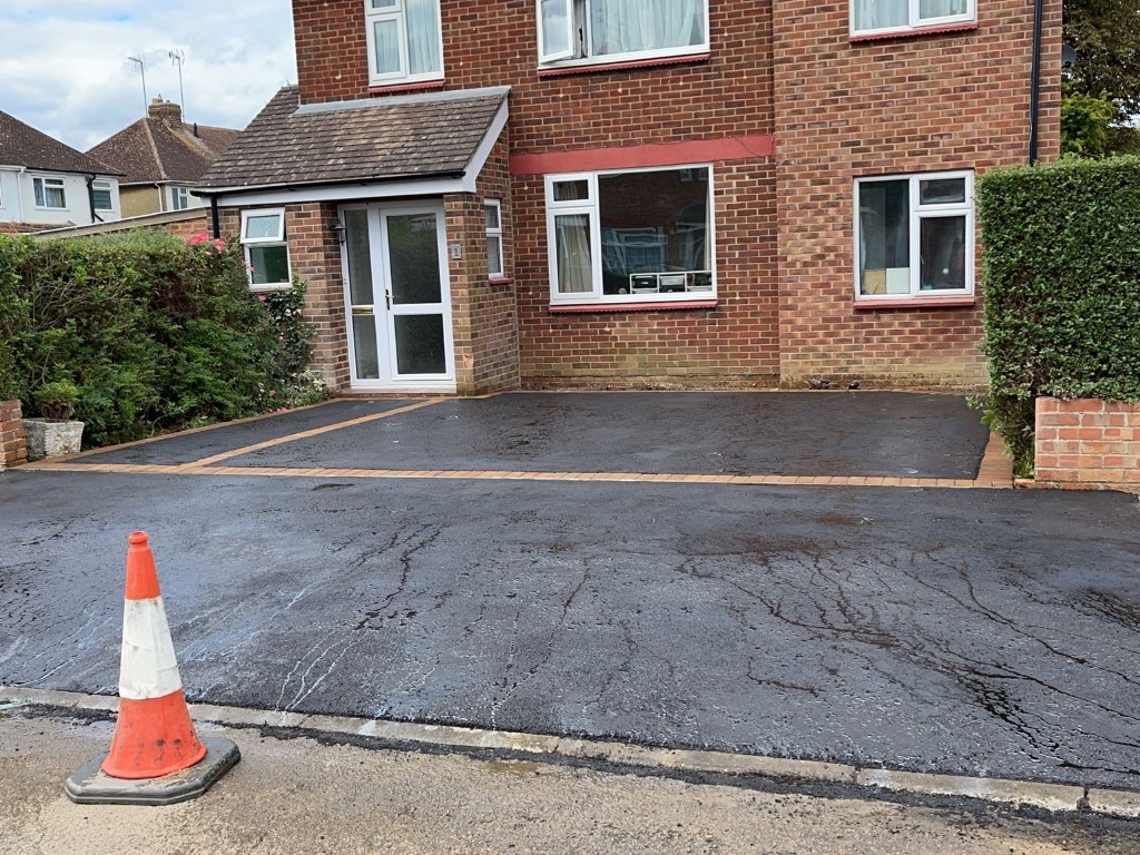 Laying asphalt surfacing in Compton, Surrey