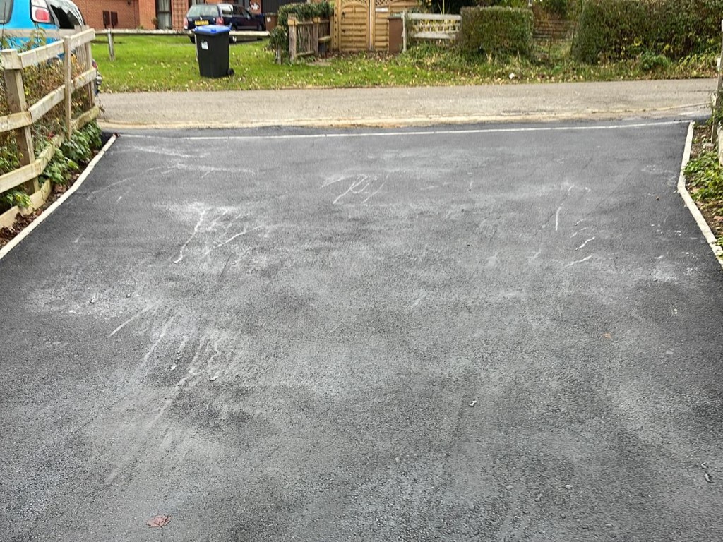Laying tarmacadam surfacing in Grafham, Surrey