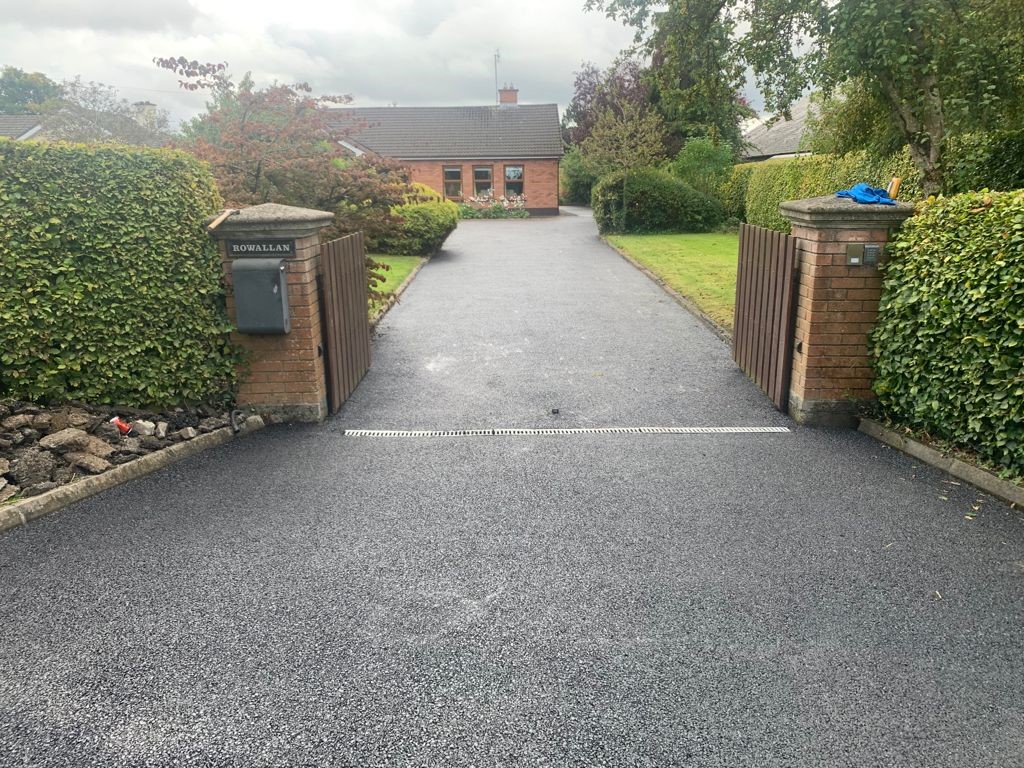 Laying tarmacadam surfacing in Thorncombe Street, Surrey